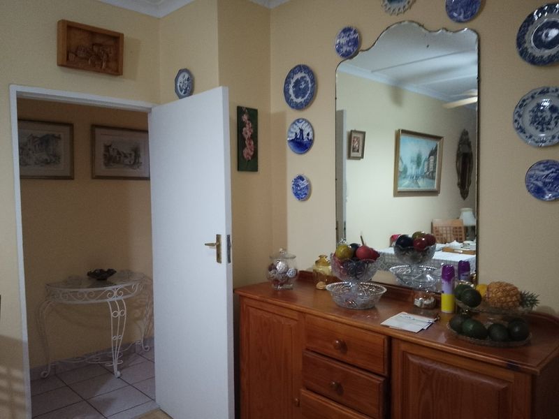 A functional hallway area featuring tiled flooring and coving, providing access to adjacent rooms within the townhouse.