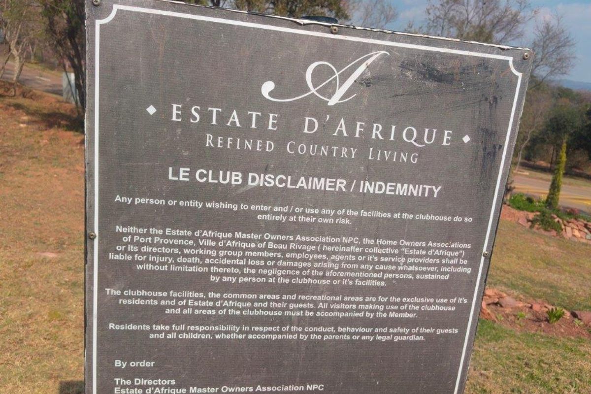 A signage board displaying the disclaimer and indemnity terms for the Estate d'Afrique clubhouse facilities.