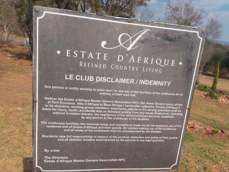 A signage board displaying the disclaimer and indemnity terms for the Estate d'Afrique clubhouse facilities.
