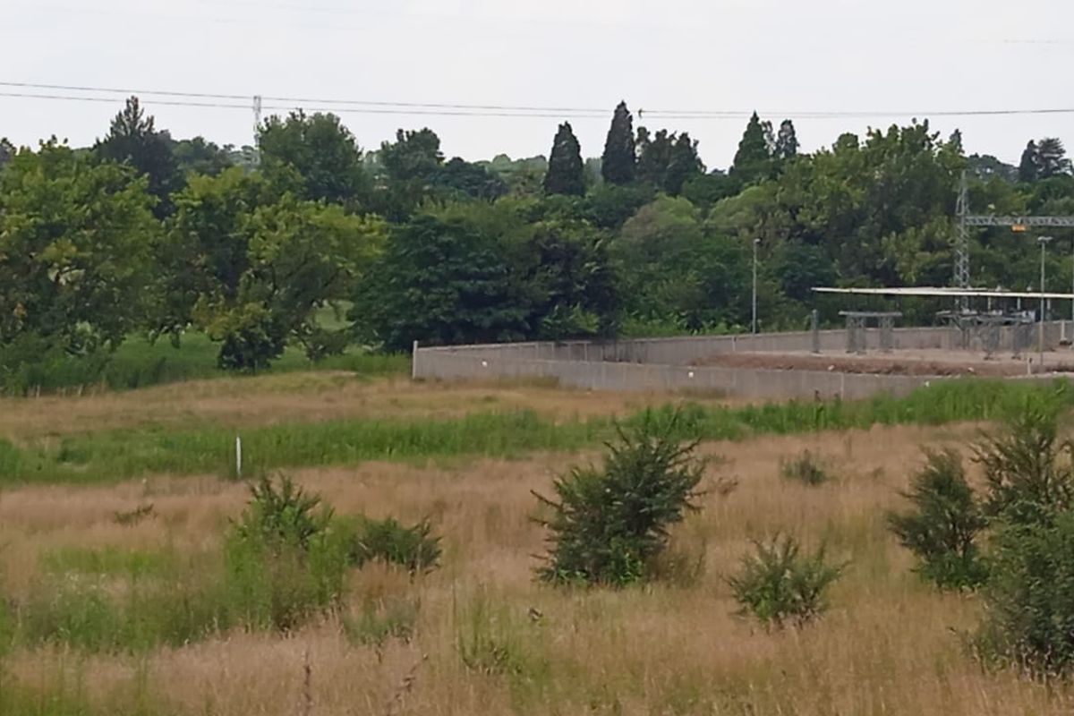 A view of the vacant residential land showing surrounding vegetation and adjacent electrical substation infrastructure.