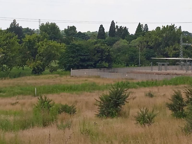 A view of the vacant residential land showing surrounding vegetation and adjacent electrical substation infrastructure.