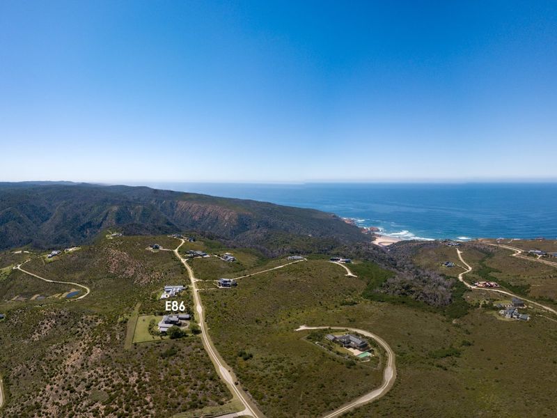 An aerial view of the coastal estate landscape, highlighting the property location and surrounding natural terrain with ocean views.