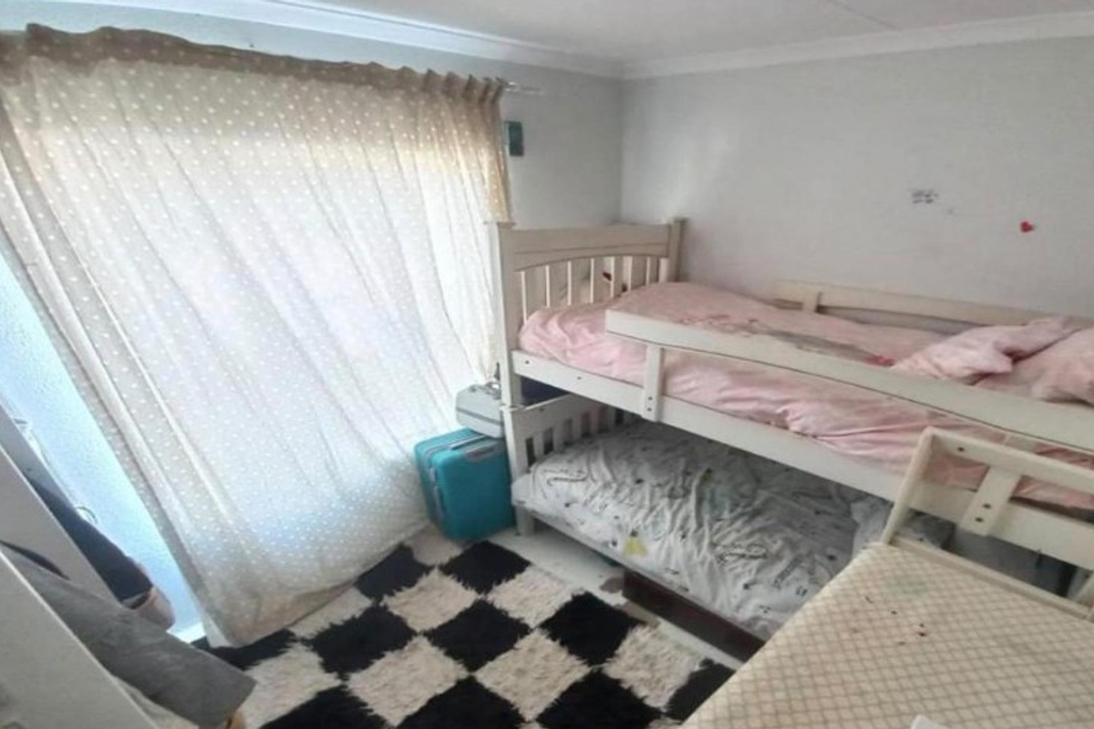 A compact bedroom featuring neutral walls, coving, and a large window with curtain rail, requiring minor cosmetic updates to improve its overall condition.