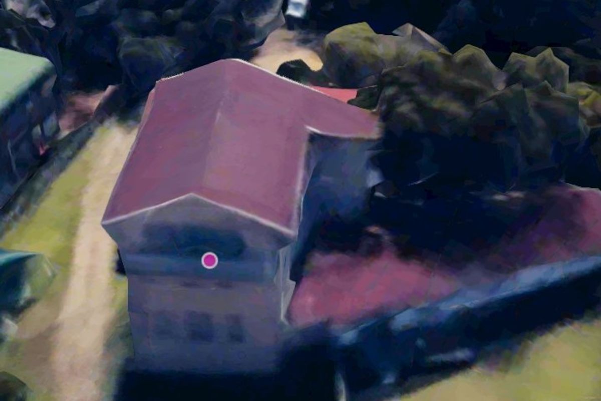 An aerial view of the property showing the building structure and surrounding grounds.