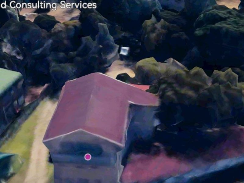 An aerial view of the commercial property showing the building structure and surrounding grounds.