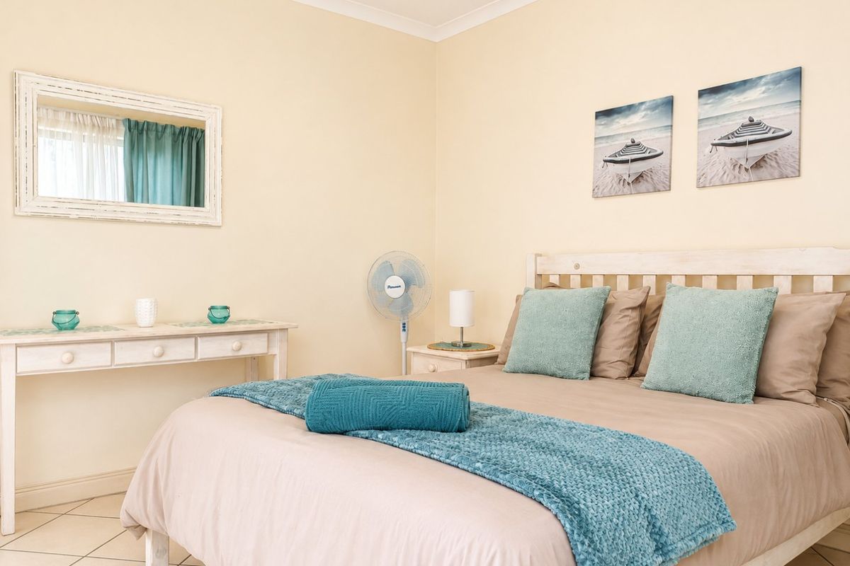 A well-maintained bedroom featuring neutral wall tones, tiled flooring, and coved ceiling details, offering a comfortable and functional living space.