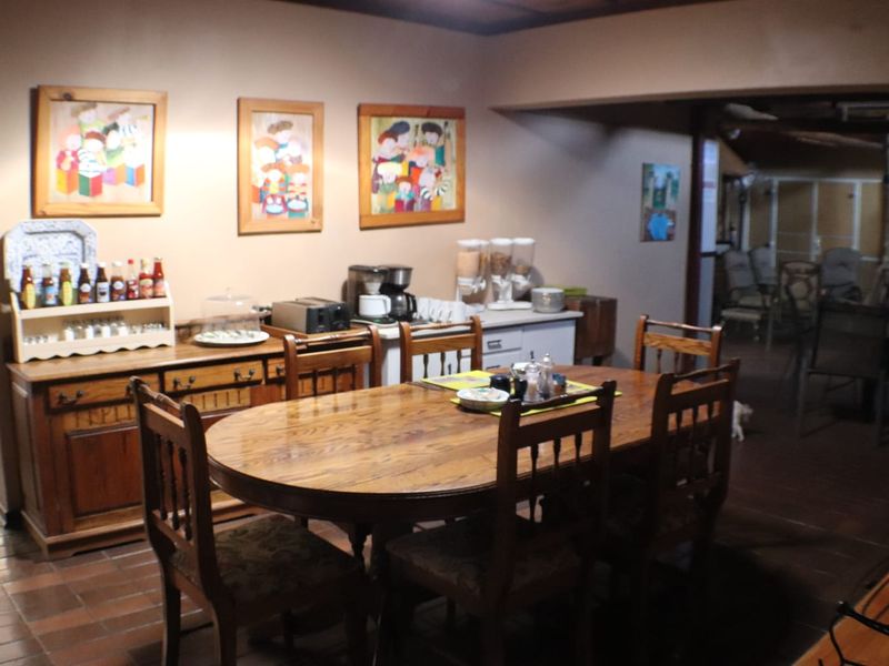 A dining area featuring tiled flooring and built-in wooden cabinetry, providing a functional space for meals.