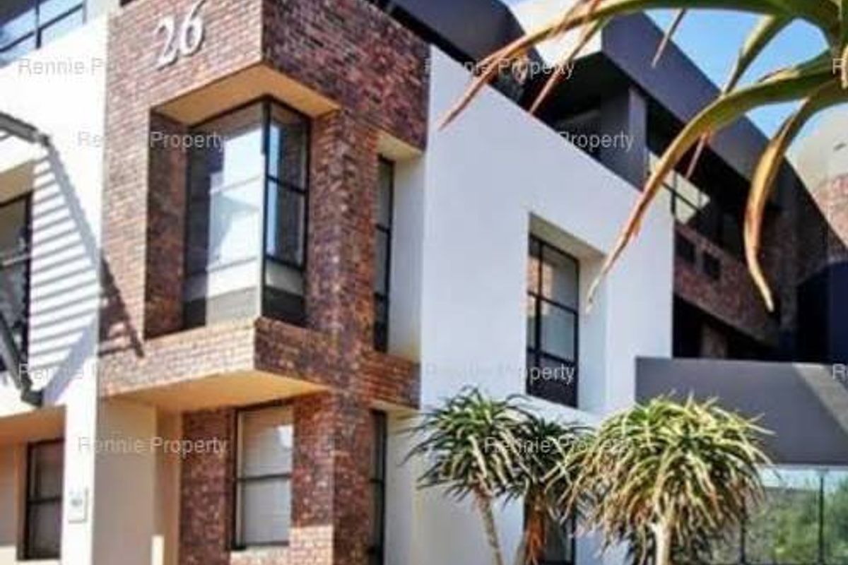 Modern commercial building facade featuring a combination of textured brickwork and large glass windows, presenting a professional and contemporary architectural aesthetic.