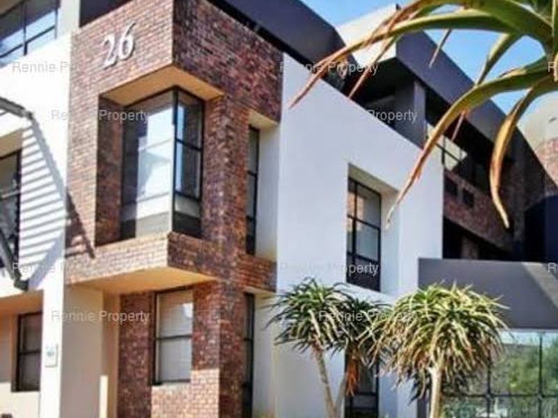 Modern commercial building facade featuring a combination of textured brickwork and large glass windows, presenting a professional and contemporary architectural aesthetic.