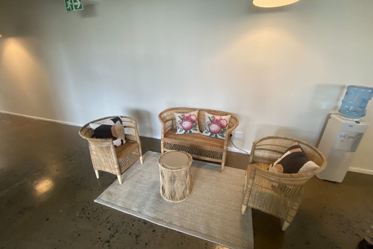 A commercial waiting area featuring polished concrete floors, neutral walls, and integrated lighting, providing a clean and professional atmosphere.