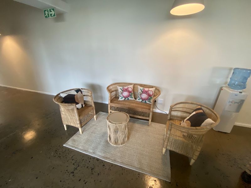 A commercial waiting area featuring polished concrete floors, neutral walls, and integrated lighting, providing a clean and professional atmosphere.