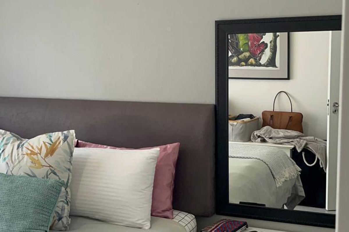 A well-maintained bedroom featuring neutral wall tones, tiled flooring, and clean architectural finishes, providing a comfortable and functional living space.
