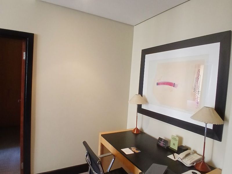 A well-maintained office space featuring neutral wall finishes, recessed ceiling lighting, and carpeted flooring.