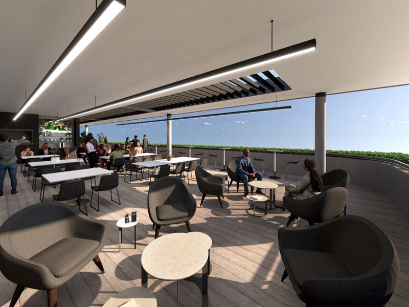 A modern, expansive covered outdoor balcony featuring timber-look decking, integrated lighting, and a louvre roof system, offering an ideal space for commercial social gatherings.