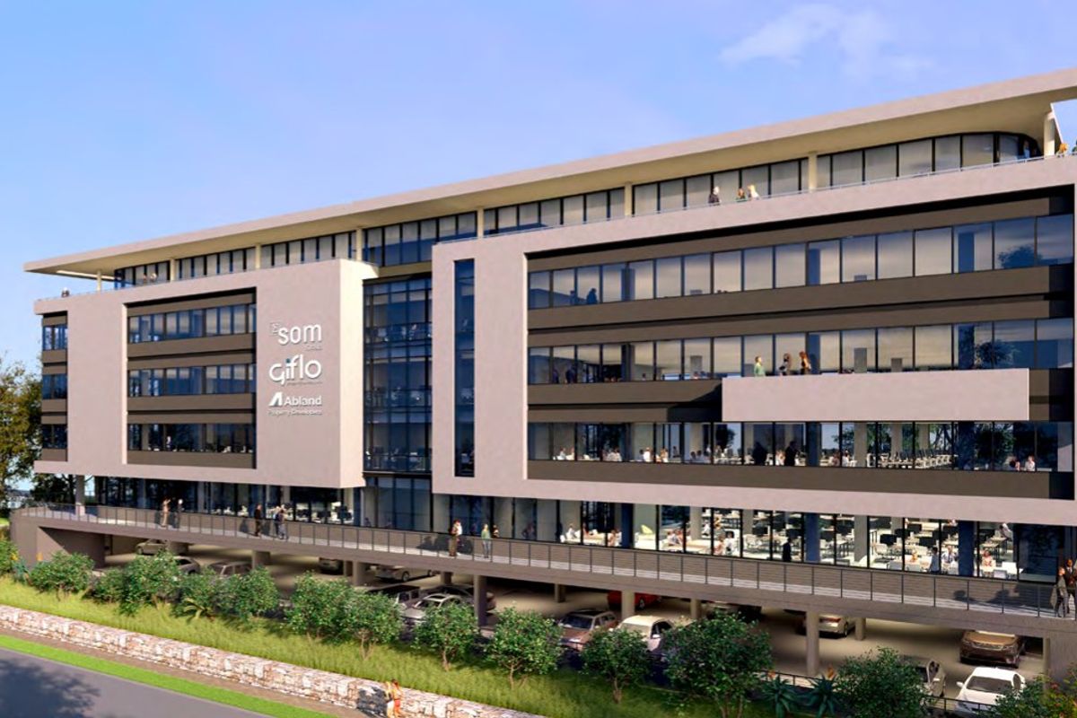 Modern multi-story commercial office building featuring a glass facade, integrated covered parking, and multiple balconies.