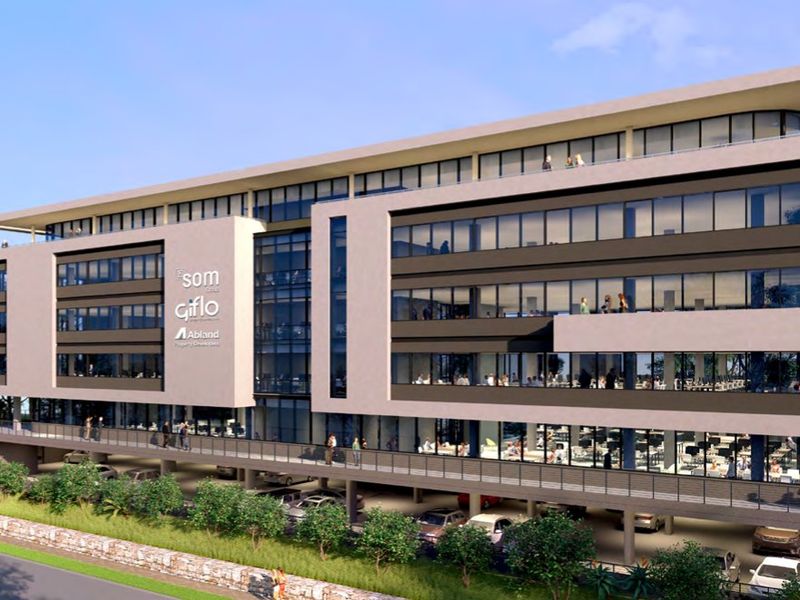 Modern multi-story commercial office building featuring a glass facade, integrated covered parking, and multiple balconies.