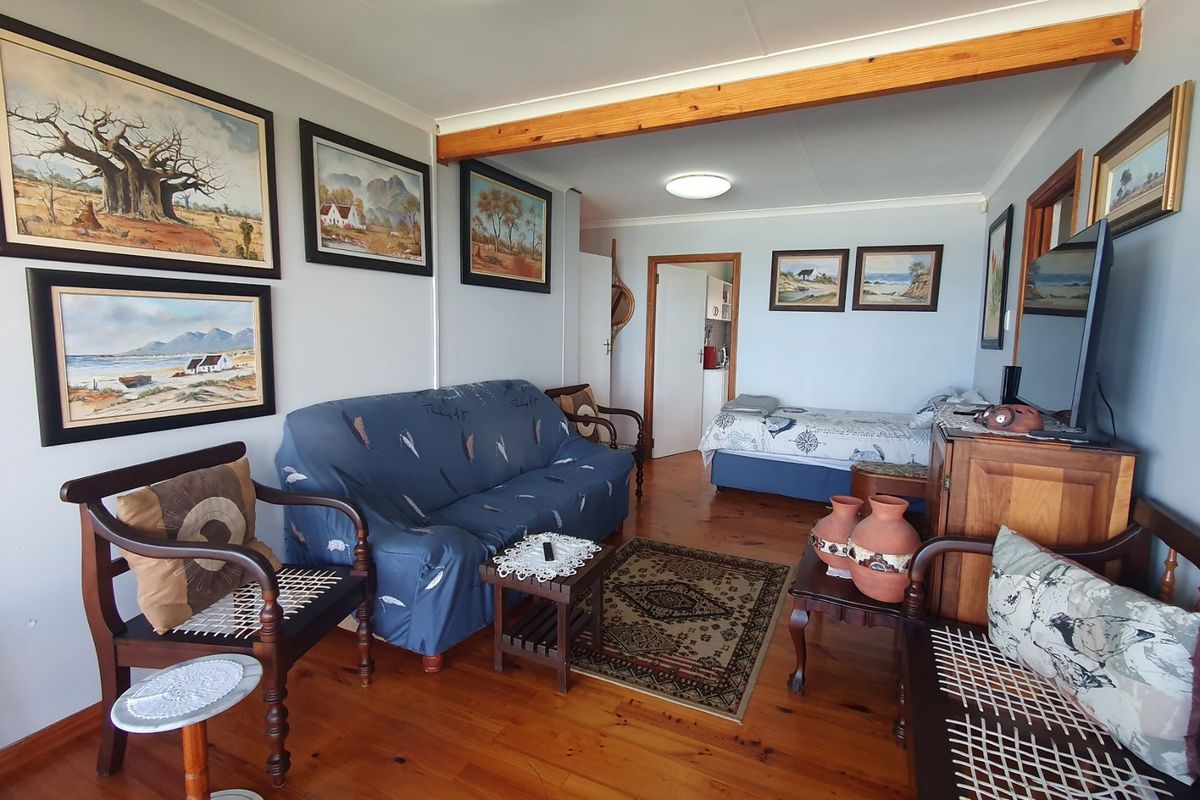 A living area featuring warm timber flooring and an exposed timber ceiling beam, providing a traditional and cozy atmosphere.