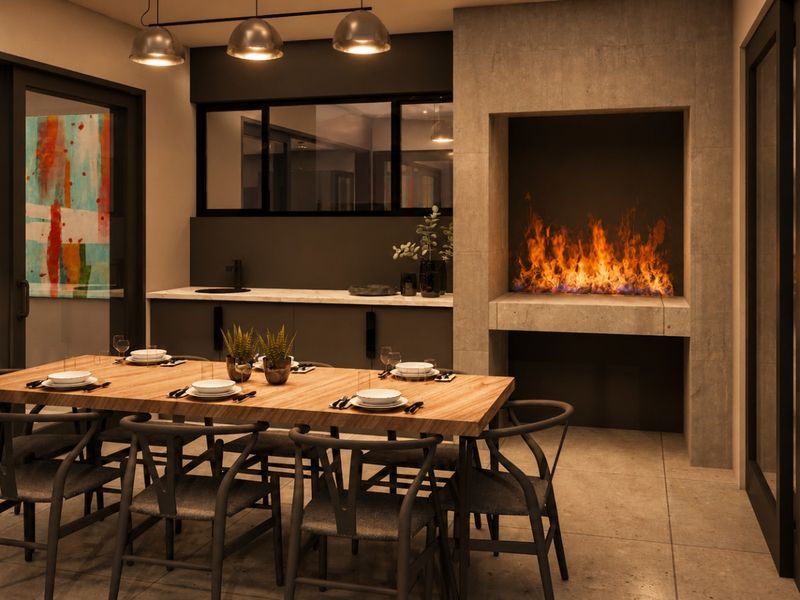 Modern dining area featuring a built-in fireplace, stone-topped wet bar, and large sliding glass doors opening to the exterior.