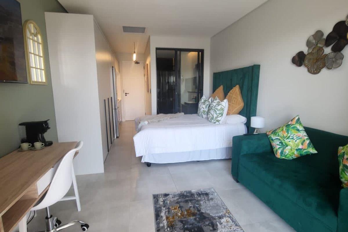 Modern open-plan studio apartment featuring tiled flooring, built-in cabinetry, and ducted air conditioning, offering a functional and well-maintained living space.