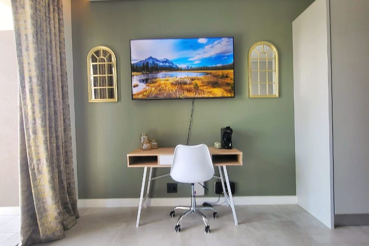 A well-maintained bedroom featuring neutral tiled flooring, a built-in wardrobe, and recessed ceiling lighting, creating a clean and functional living space.