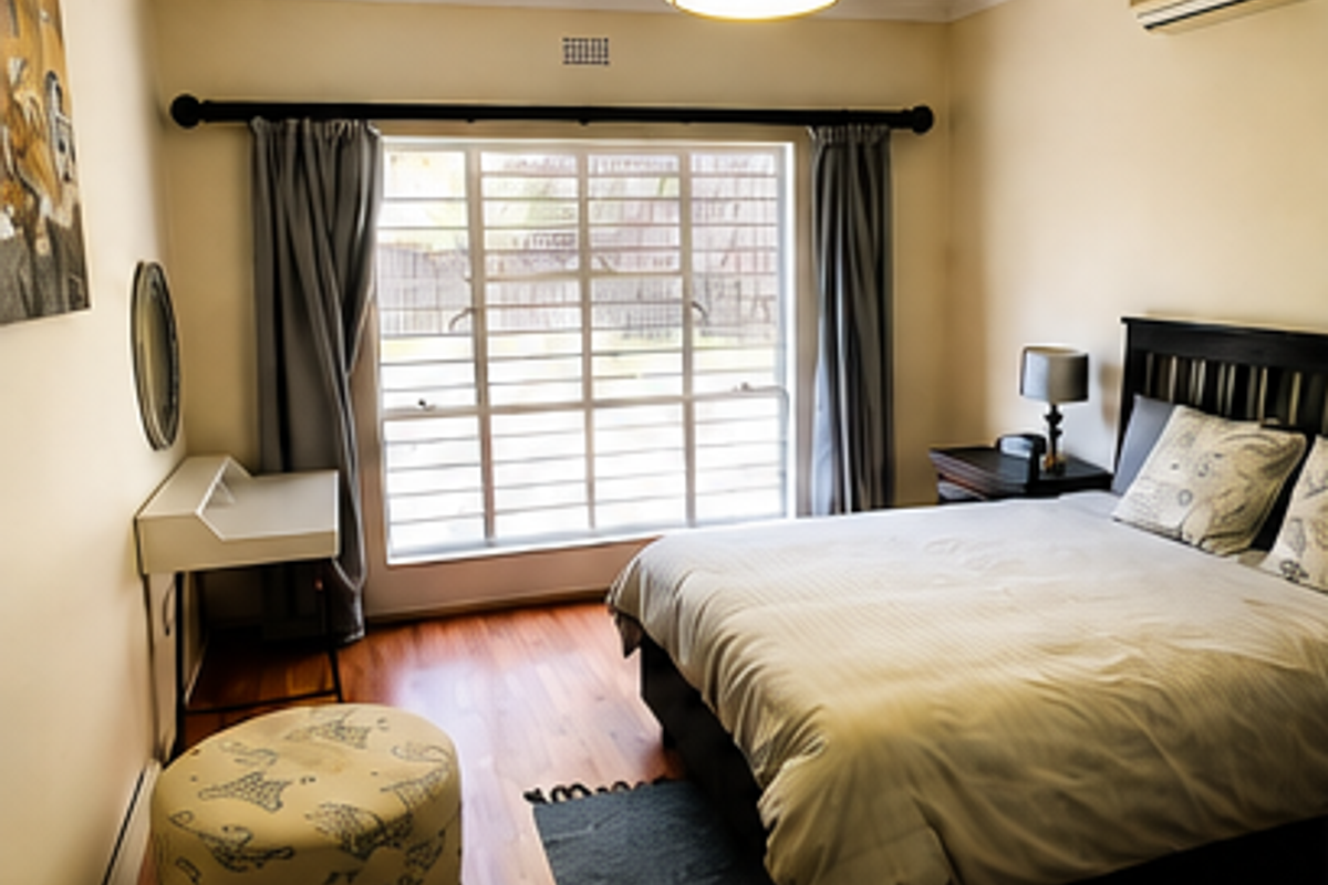 A well-maintained bedroom featuring laminate flooring, a split-system air conditioner, and large windows fitted with security bars for added peace of mind.