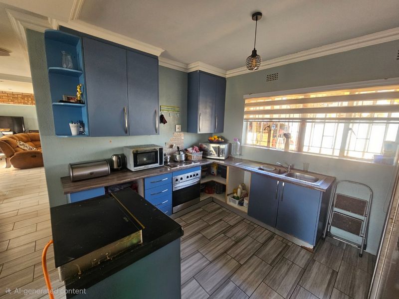 A functional kitchen featuring blue cabinetry, laminate countertops, a built-in oven, and tiled flooring, requiring some maintenance and cosmetic updates.