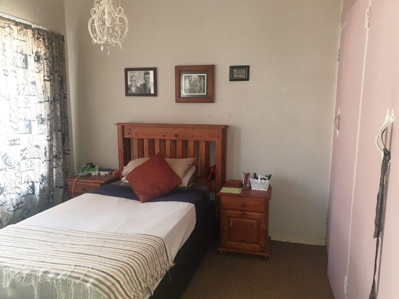 A standard bedroom featuring carpeted flooring and a built-in wardrobe, providing a functional living space.