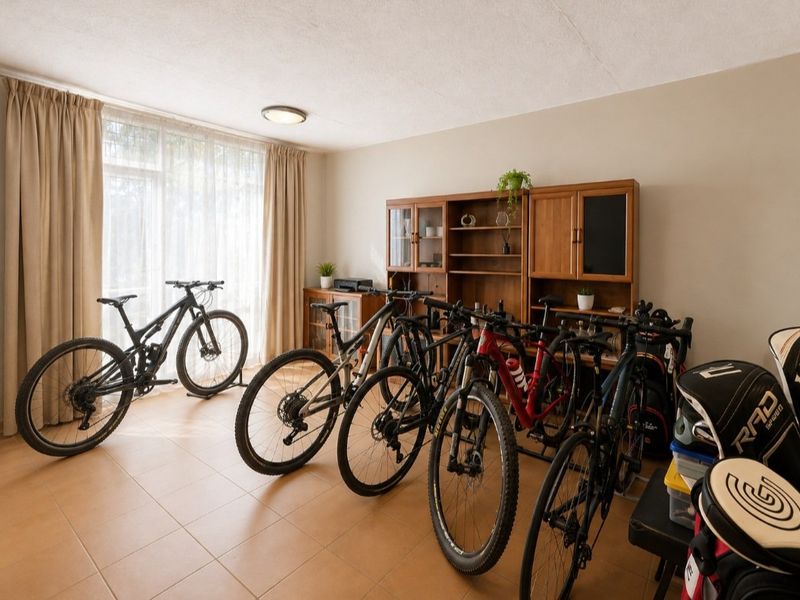 A spacious living area featuring neutral tiled flooring and a large sliding glass door that provides ample natural light.