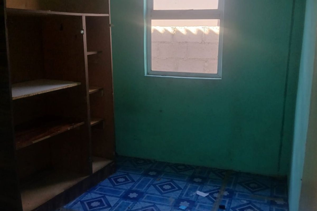 A small, vacant bedroom featuring tiled flooring and a single window, requiring cosmetic updates to improve its overall appeal and condition.