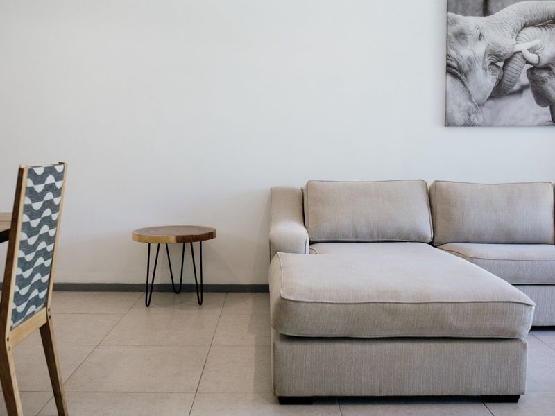 A well-maintained living area featuring neutral tiled flooring and clean wall finishes, providing a bright and comfortable space.
