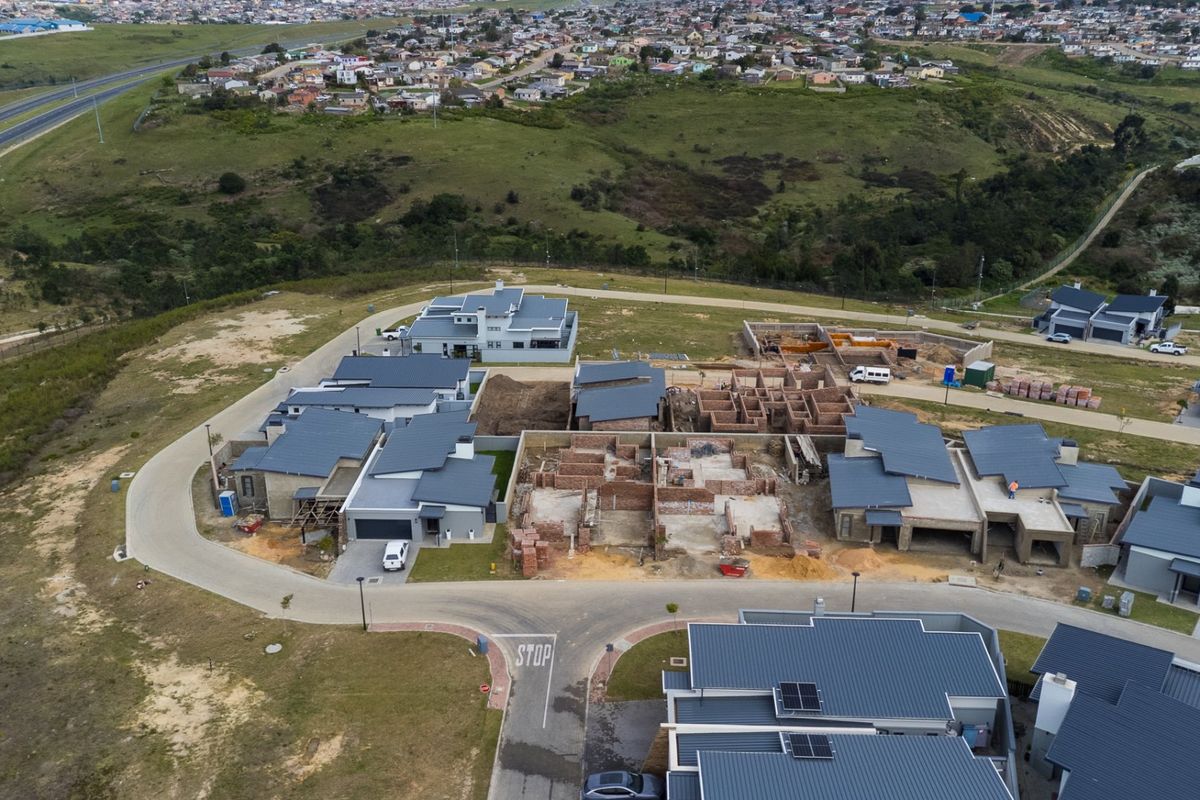 Aerial view of a residential development estate showing completed homes and ongoing construction of new housing units.