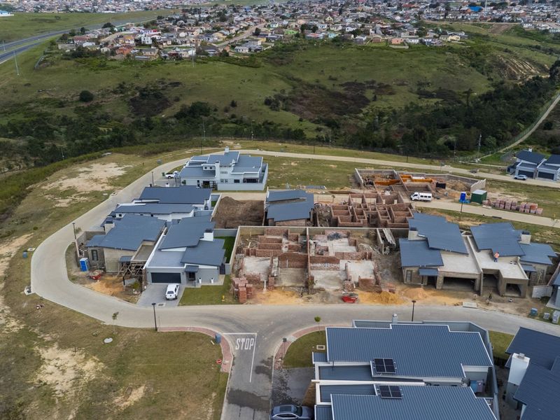 Aerial view of a residential development estate showing completed homes and ongoing construction of new housing units.
