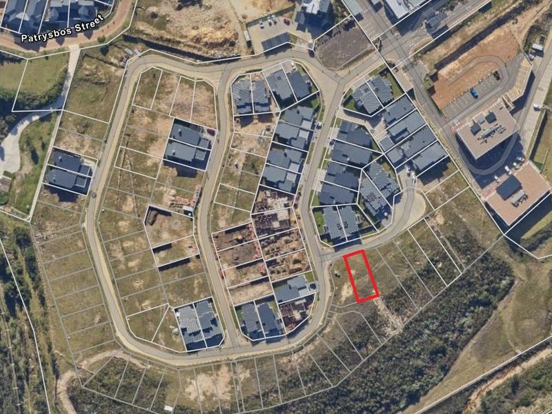 Aerial view of a vacant residential plot within a developed estate, highlighting the property boundaries and surrounding neighborhood infrastructure.