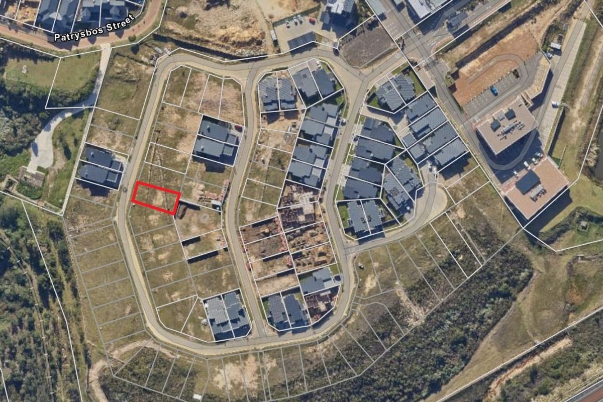 Aerial view of a vacant residential plot within a developed estate, highlighting the property boundaries and surrounding infrastructure.