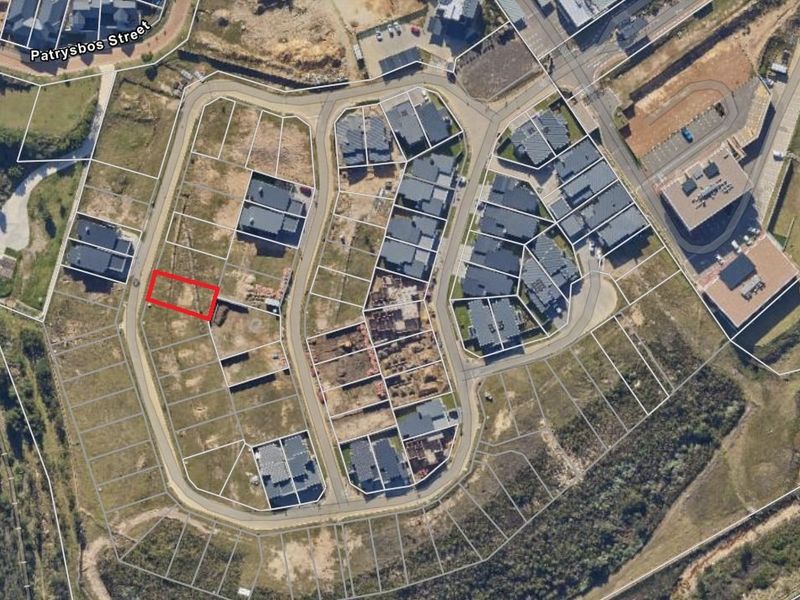 Aerial view of a vacant residential plot within a developed estate, highlighting the property boundaries and surrounding infrastructure.