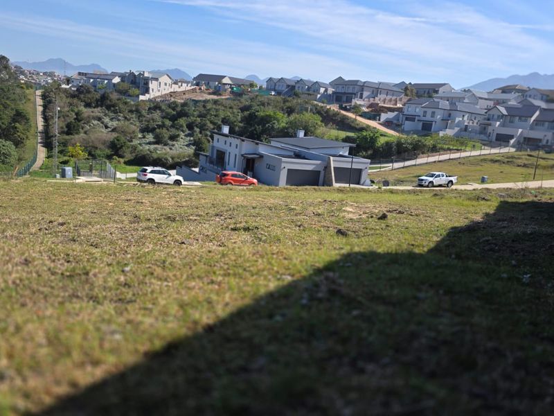 An elevated view overlooking a residential estate with surrounding landscape and neighboring properties.