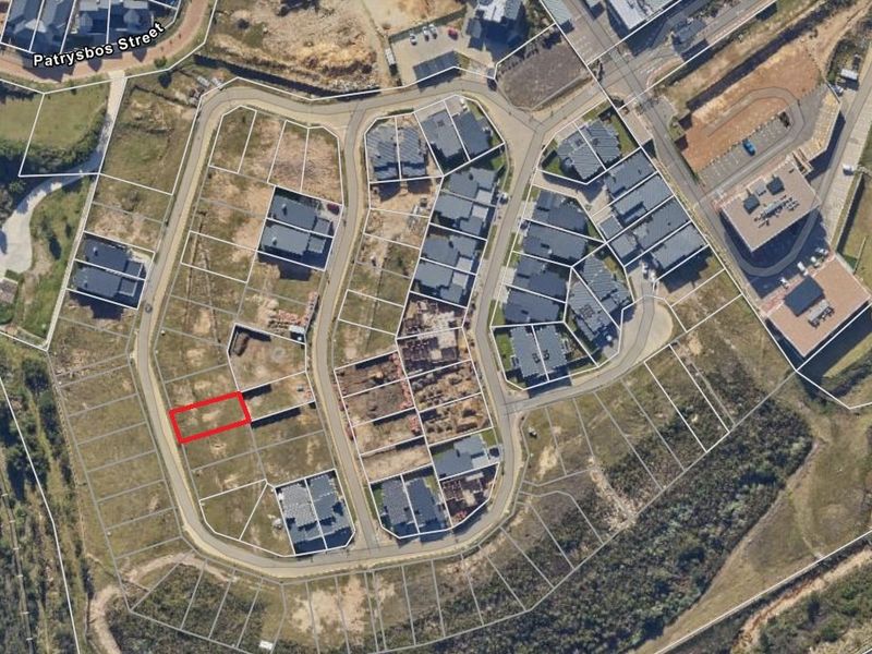 An aerial view of a residential development showing the highlighted vacant plot within the estate layout.