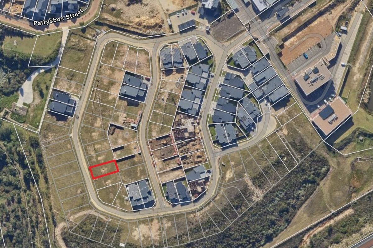 Aerial view of a residential development site highlighting a specific vacant plot within the estate layout.