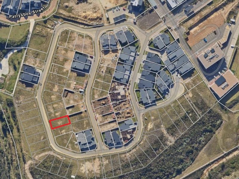 Aerial view of a residential development site highlighting a specific vacant plot within the estate layout.