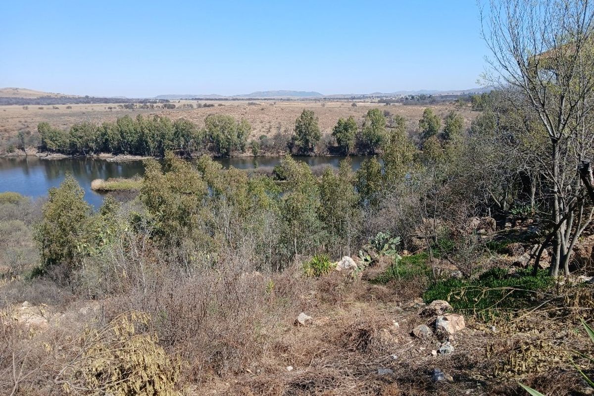 A scenic view overlooking a river and natural landscape, showcasing the tranquil surroundings of the vacant residential land.