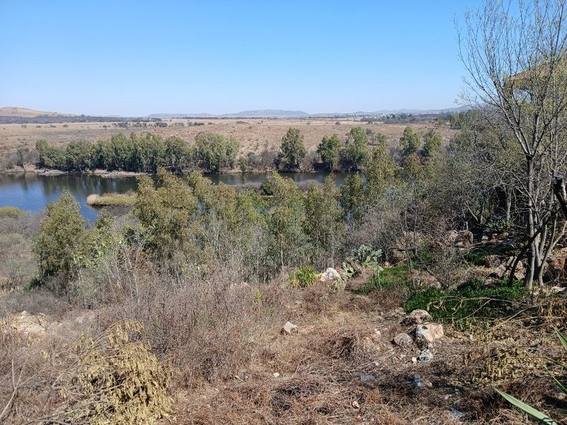 A scenic view overlooking a river and natural landscape, showcasing the tranquil surroundings of the vacant residential land.