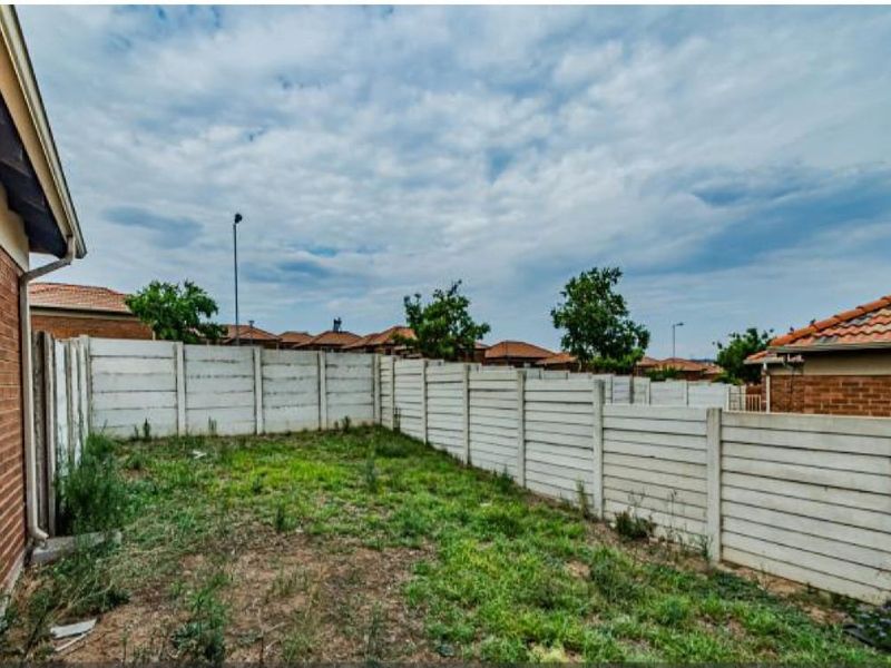 A private rear garden area featuring a precast concrete boundary wall and brick exterior walling, offering potential for landscaping and outdoor improvement.