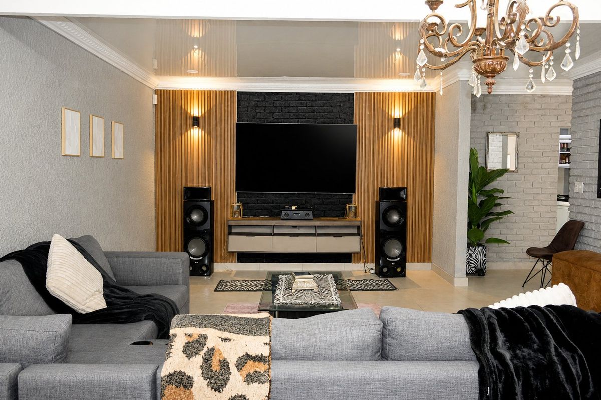 A modern living room featuring a striking timber slat and black brick feature wall, complemented by recessed lighting and elegant crown molding.