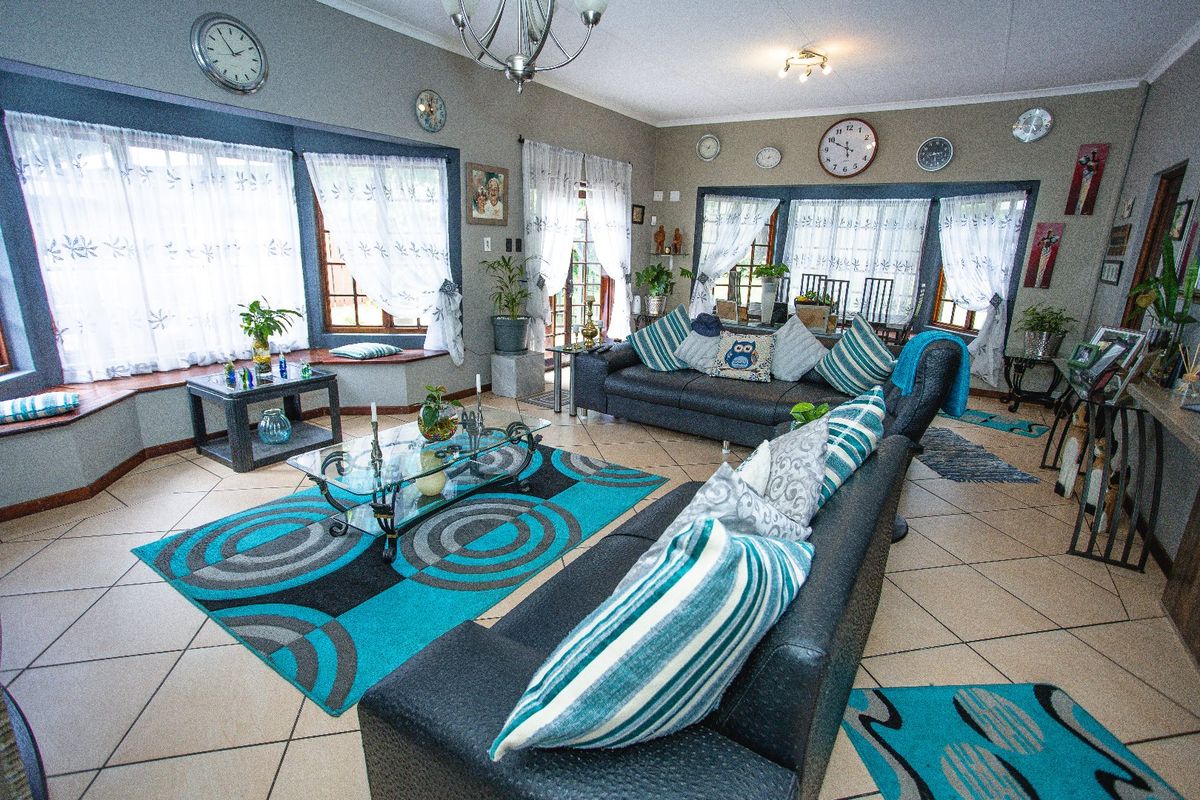 Spacious living room featuring tiled flooring, a large bay window with built-in seating, and ample natural light.