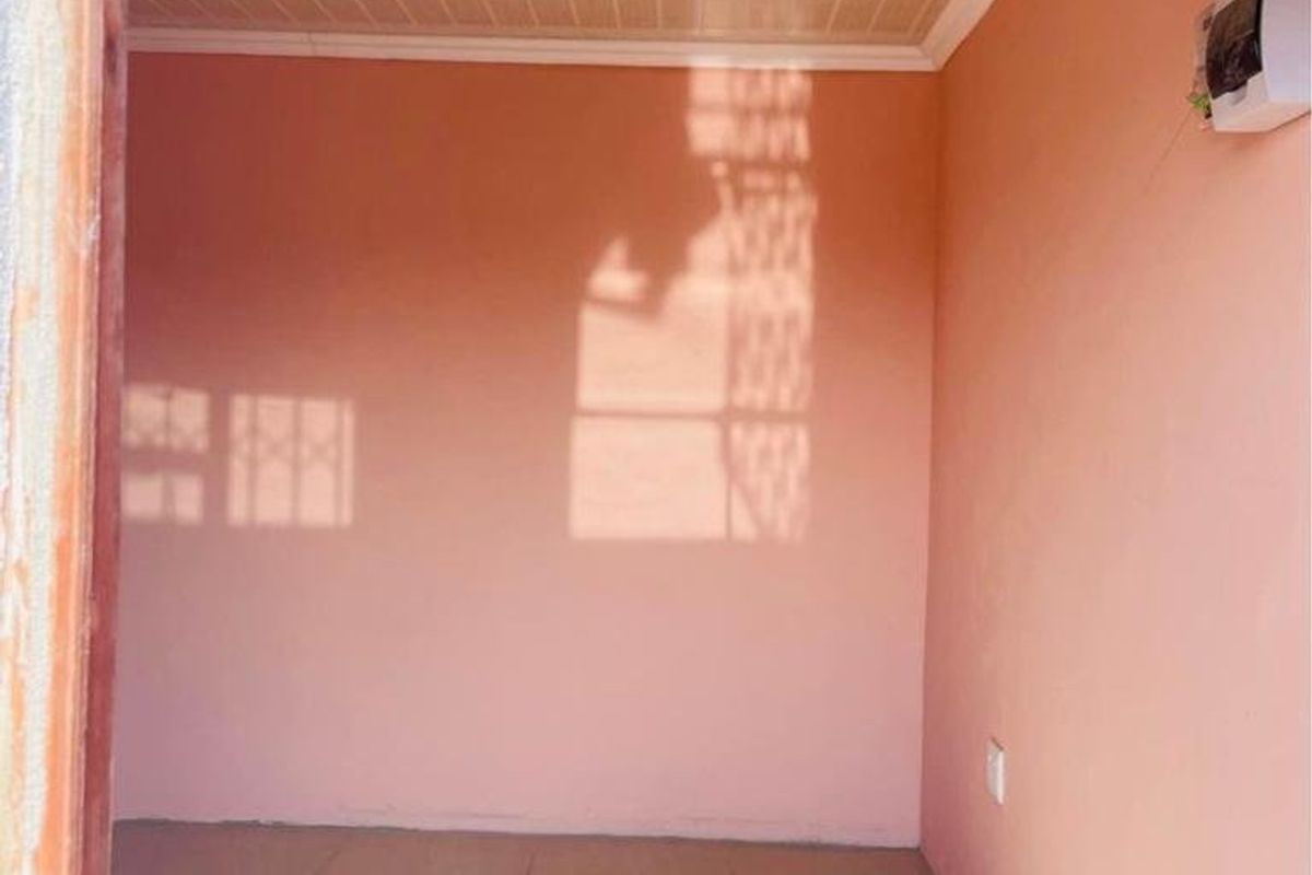 An empty bedroom featuring tiled flooring, PVC ceiling panels, and a wall-mounted electrical distribution board.