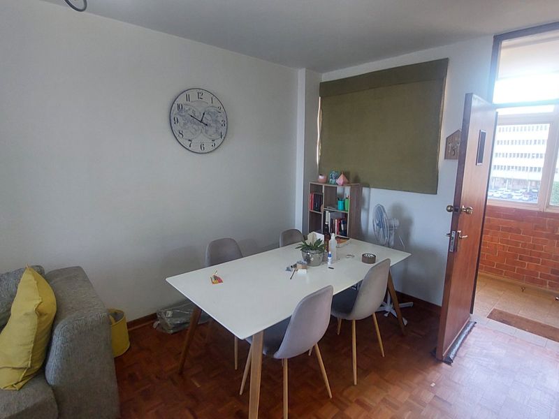 Dining area featuring parquet flooring and direct access to an outdoor balcony space.