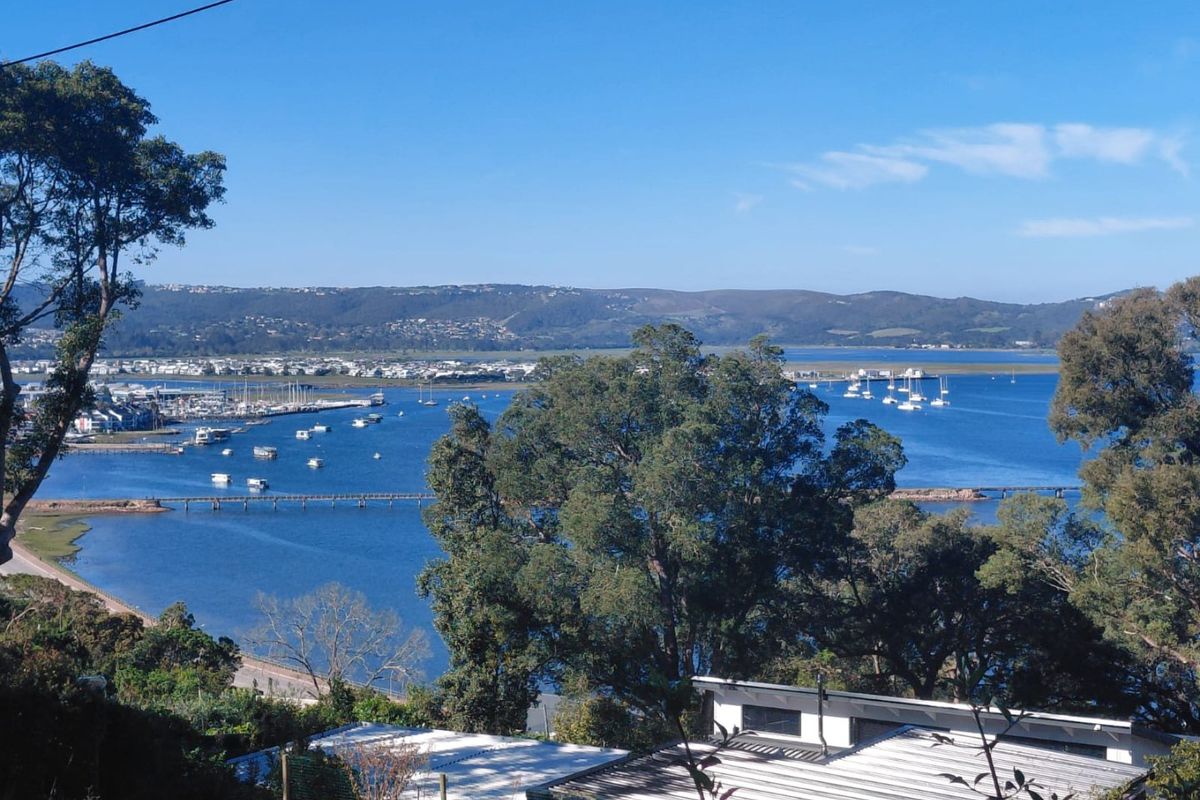A scenic elevated view overlooking the lagoon, marina, and surrounding landscape, highlighting the property's prime coastal location.