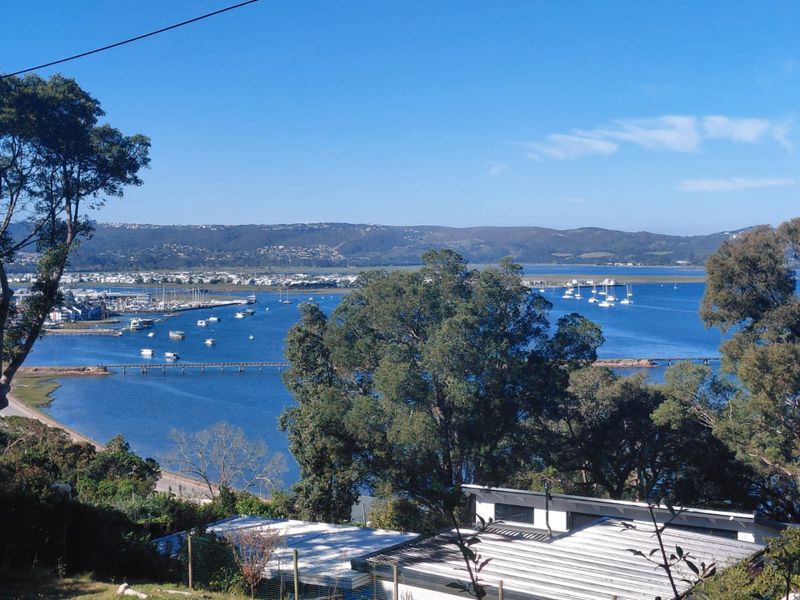 A scenic elevated view overlooking the lagoon, marina, and surrounding landscape, highlighting the property's prime coastal location.
