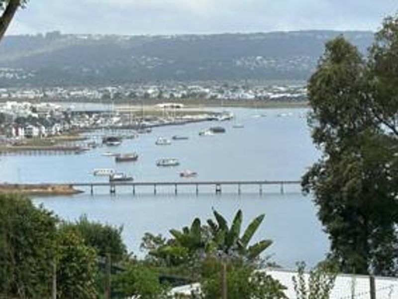 A scenic elevated view overlooking the estuary, bridge, and surrounding coastal landscape.
