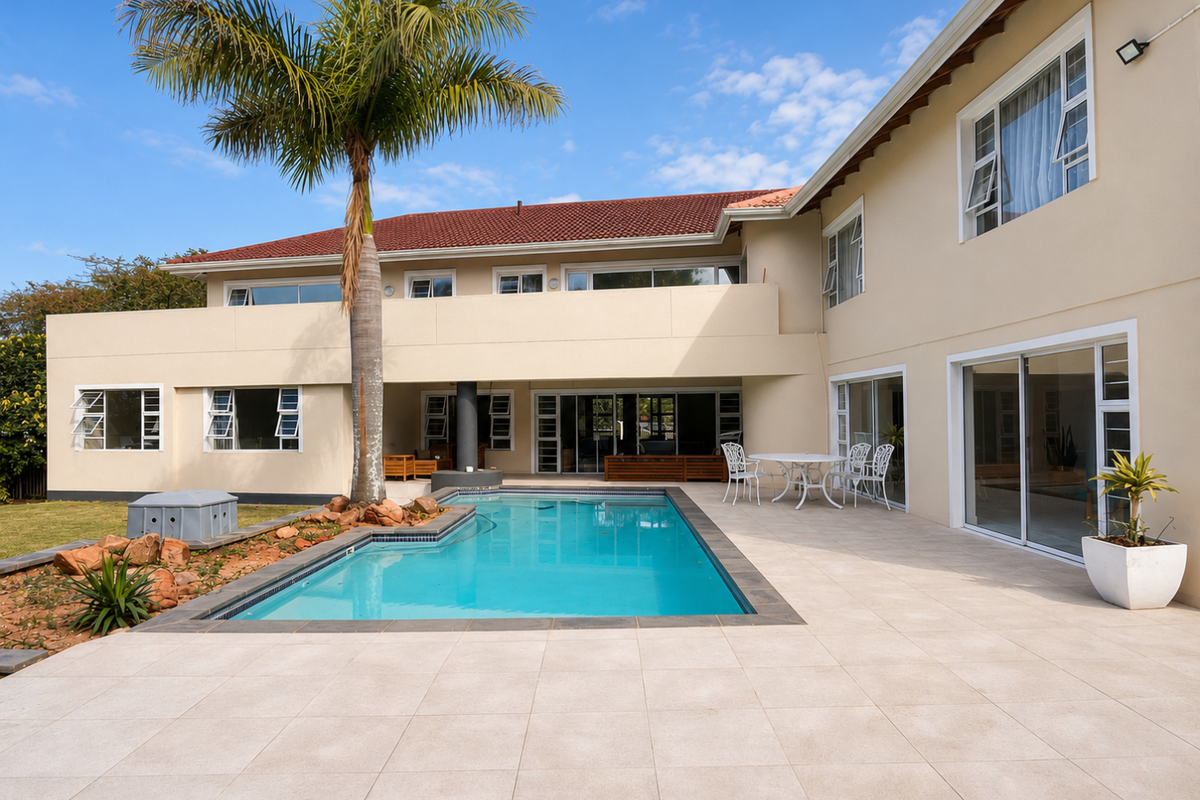 Spacious rear exterior featuring a swimming pool, large tiled patio area, and multiple sliding glass doors providing seamless indoor-outdoor flow.